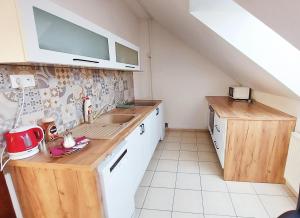 a kitchen with a sink and a counter top at Apartmán pre 5 osôb, 2 spálne, Banská Bystrica Podlavice 24h self checkin in Banská Bystrica +28 photos