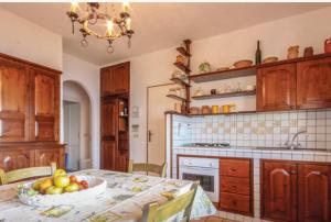 a kitchen with a table with a bowl of fruit on it at Villa Tina Tropea Costa dei Monaci Parghelia, sabbia fine e bianca e mare cristallino in Mandaradoni