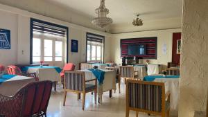 a restaurant with tables and chairs and a television at New Park Hotel in Amman