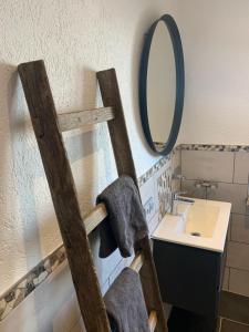 a bathroom with a wooden ladder next to a sink at Ferienwohnung Maier Schliersee Neuhaus in Schliersee