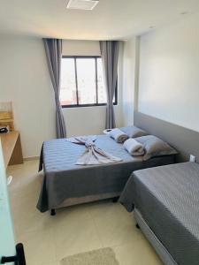 a bedroom with a bed and a window at APARTAMENTO PONTA VERDE - MACEIO-AL in Maceió