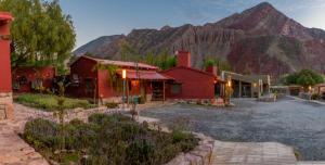 a group of buildings with a mountain in the background at Ecohotel Posta de Purmamarca in Purmamarca