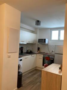 a kitchen with white cabinets and a counter top at Zilarelle in Ajaccio