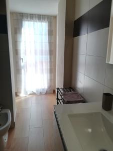 a kitchen with a stove and a sink in a room at casa mariuccia in San Nicola La Strada