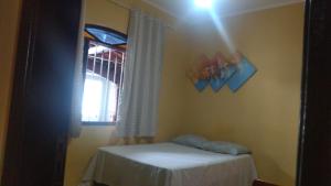 a room with a table and a window at Casa Temporada a 3 quadra da Praia in Praia Grande