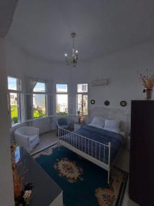 a bedroom with a bed and a living room at Tower traditional pool villa in Kremasti