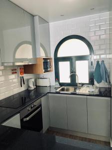 a kitchen with a sink and a window at Ocean Cliffs Apartments in Funchal