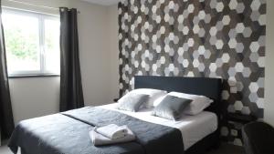 a bedroom with a bed with two towels on it at Côté Grange in Tournai