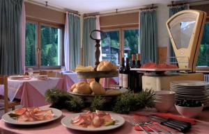 une table avec des assiettes de nourriture au-dessus dans l'établissement Casa per Ferie Villa Romagna, à Pozza di Fassa