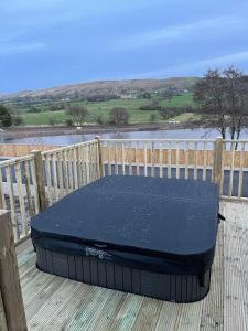 a mattress sitting on a deck next to a fence at 5 Lake View, Barrow, Clitheroe - in the heart of the Ribble Valley in Pendleton