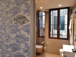 a bathroom with a mural of fish on the wall at Hotel Aquarius Venice - Ascend Collection in Venice
