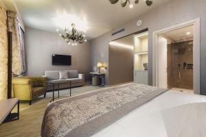 a bedroom with a bed and a living room at Hotel Aquarius Venice - Ascend Collection in Venice