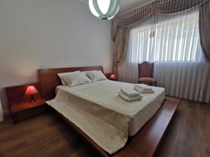 a bedroom with a bed with two towels on it at VIVENDA TABORDA in Viana do Castelo +31 photos