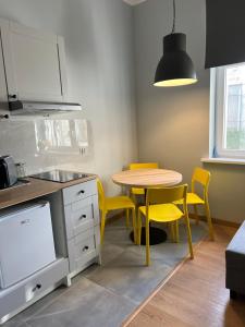 a kitchen with a table and chairs in it at Plac Katarzyny 13 in Toruń
