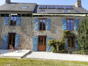 a house with solar panels on the roof at Gites Les Coudreaux in Saint-Siméon