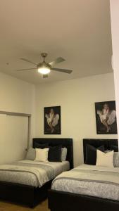two beds in a room with two pictures on the wall at Exceptional Loft FREE Parking and WIFI in Los Angeles