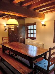 a wooden table and two chairs in a room at Eden Cottage in Saint-Gâtien-des-Bois