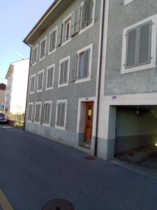 a building with a door on the side of a street at VIP Appartment Centre Payerne in Payerne