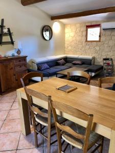 a living room with a table and a couch at Gite des oliviers in La Roque-sur-Cèze