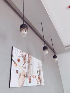 a group of lights hanging from a ceiling at Grand Thamrin Hotel in Jakarta