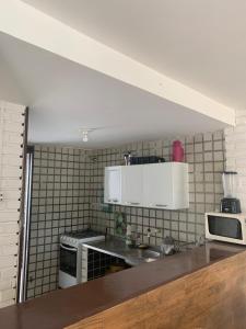 a kitchen with white appliances and a counter top at Chalé em Nossa Senhora da Conceição in Paulista