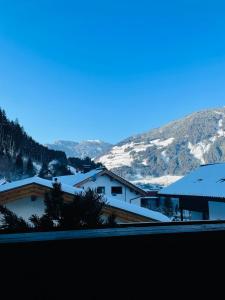 a view of snow covered buildings with mountains in the background at Ferienhaus Anna in Zell am Ziller