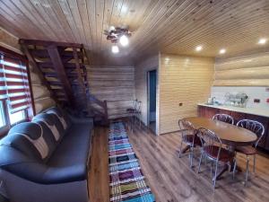 a living room with a couch and a table at У Ґазди in Synevyrsʼka Polyana
