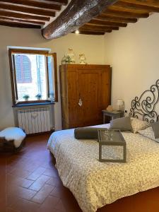 a bedroom with a bed with a table on it at Home sweet home in San Gimignano