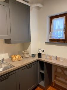 a kitchen counter with a sink and a window at Home sweet home in San Gimignano