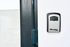 a black and white mailbox on the side of a building at Skyline hanover free parking in Swansea