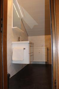 a bathroom with a white sink and a mirror at Sonnenhof in Kals am Großglockner
