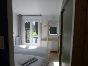 Postel nebo postele na pokoji v ubytování Gîte L'auguste Maison d'Hôtes