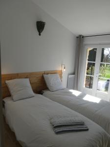 Кровать или кровати в номере Gîte L'auguste Maison d'Hôtes