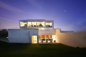 a house with a large window on the side of it at Finca Prats Hotel Golf & Spa in Lleida