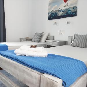 a bedroom with a bed with a towel on it at Isalos Paros in Naousa