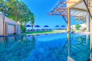 a swimming pool with a view of the ocean at Amanda Beach Villas in Unawatuna