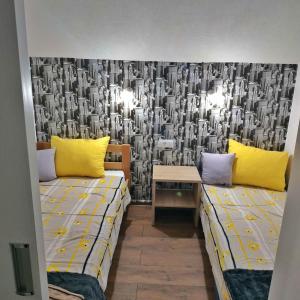 a room with two beds and a wall mural at Apartmani Zapis Vrdnik in Vrdnik