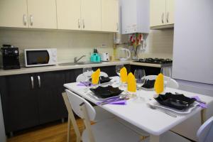 a kitchen with a table with yellow napkins on it at Romantic luxury in city center in Cluj-Napoca