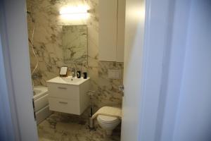 a bathroom with a toilet and a sink and a mirror at Romantic luxury in city center in Cluj-Napoca +10 photos
