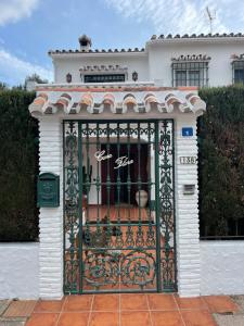 a gate in the front of a house at Casa Flora - Mijas Costa - Andalusië in Mijas