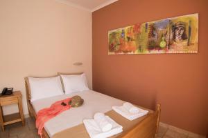 A bed or beds in a room at Atira Apartment Hotel