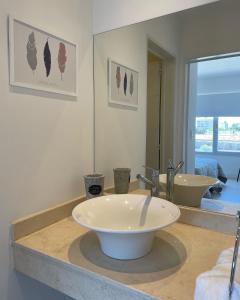 a bathroom with a large white bowl sink on a counter at Administración MAIPU 3B DEPTO PREMIUM in Tandil
