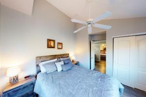 a bedroom with a bed and a ceiling fan at Crazy Horse Condo in Edwards +16 photos