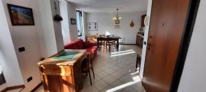 a living room with a red couch and a table at Residenza Antica Corte Villa Picta in Buglio in Monte