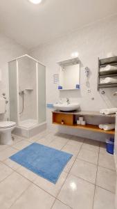 a bathroom with a sink and a shower and a toilet at IstraNova Apartments in Rovinj
