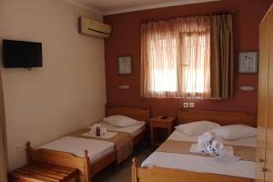 A bed or beds in a room at Atira Apartment Hotel