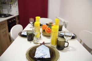 a table with plates of food and glasses of juice at Luxury Downtown Apartment in Cluj-Napoca