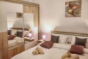 a bedroom with a large bed with a mirror at Luxury Downtown Apartment in Cluj-Napoca