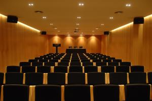 an empty lecture hall with chairs and a podium at Finca Prats Hotel Golf & Spa in Lleida