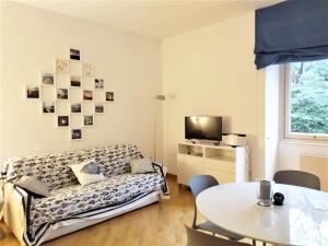 a living room with a couch and a table at CasaViva - Beautiful Bilo with shared pool in Genova Nervi in Genova